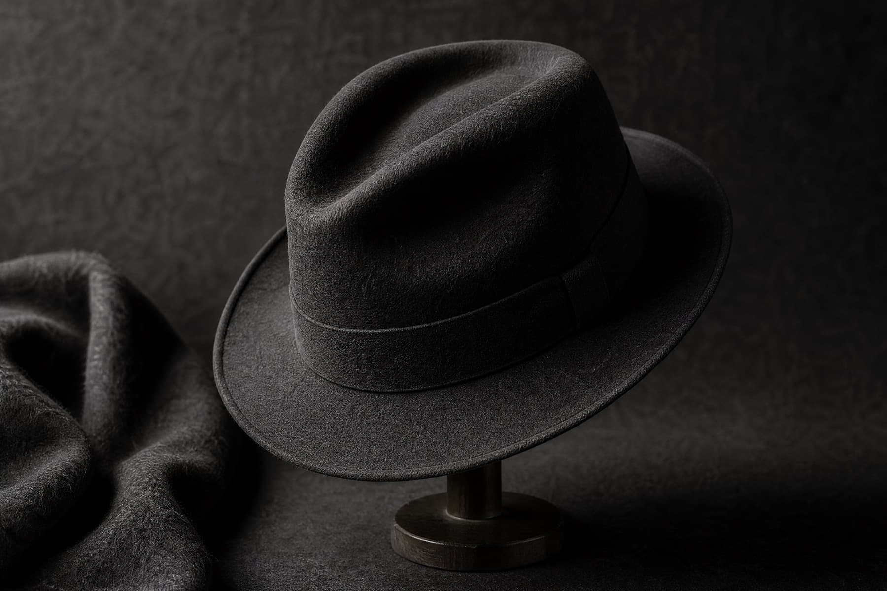 Fedora Wool 6cm: charcoal felt hat photographed whole under a single hard side light