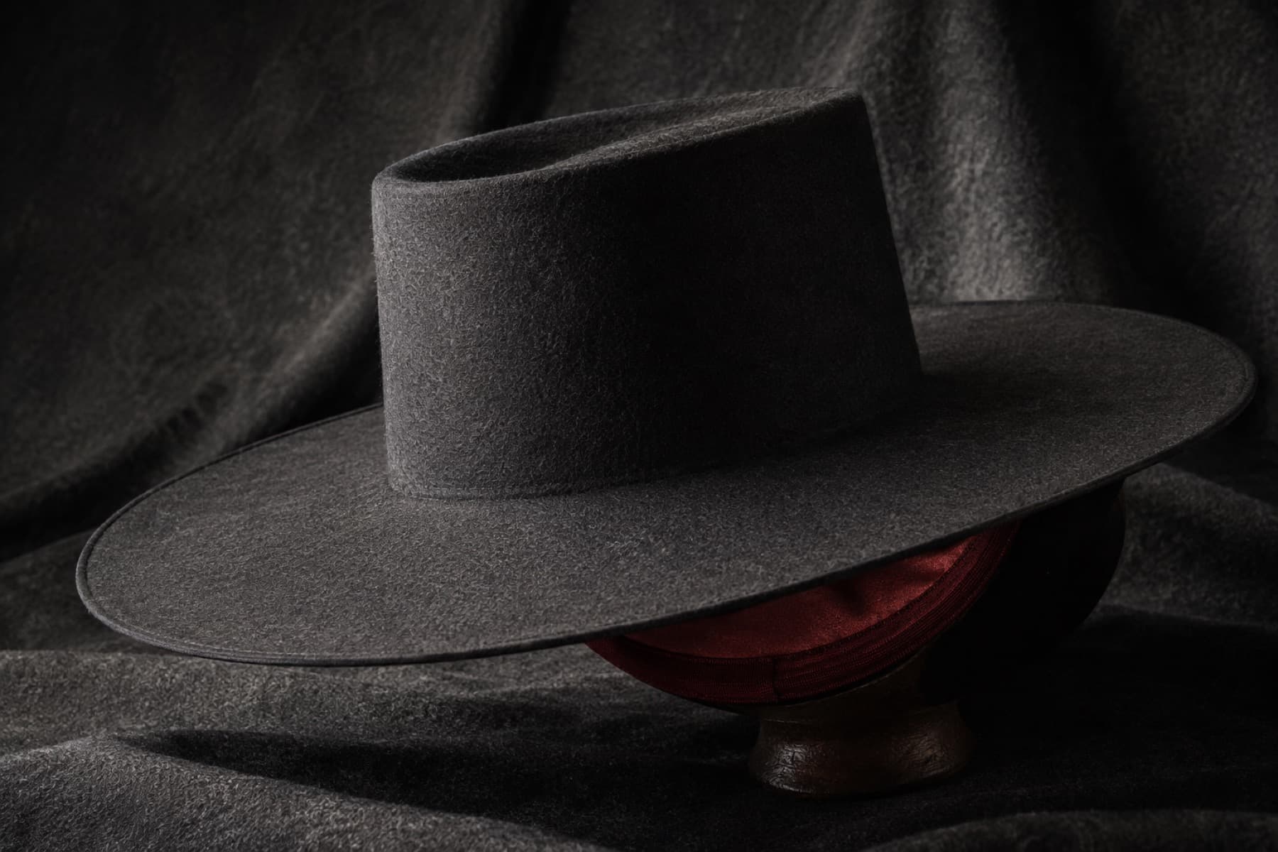 Wide 9cm Wool: charcoal felt hat photographed whole under a single hard side light