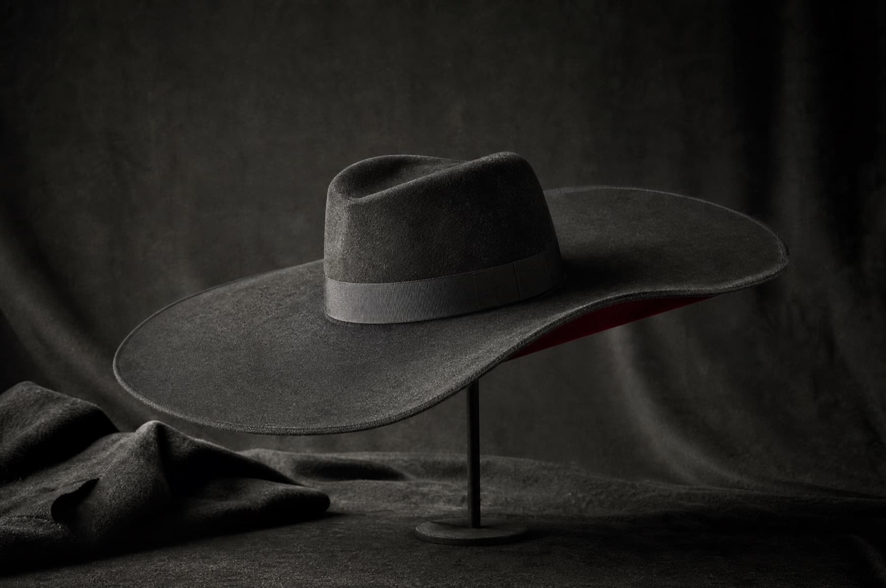 Wide Structured 12cm: charcoal felt hat photographed whole under a single hard side light