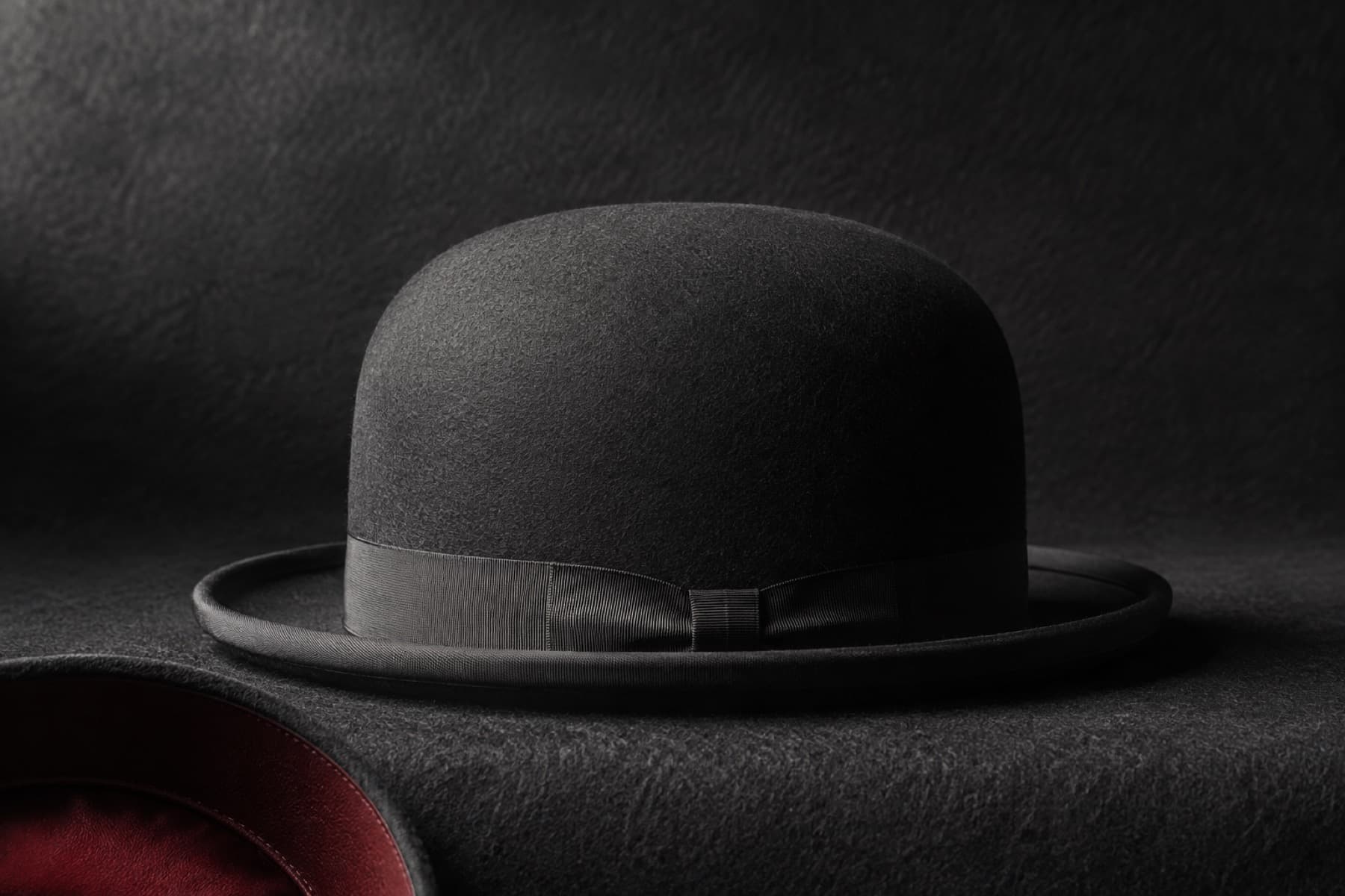 Bowler Wool: charcoal felt hat photographed whole under a single hard side light