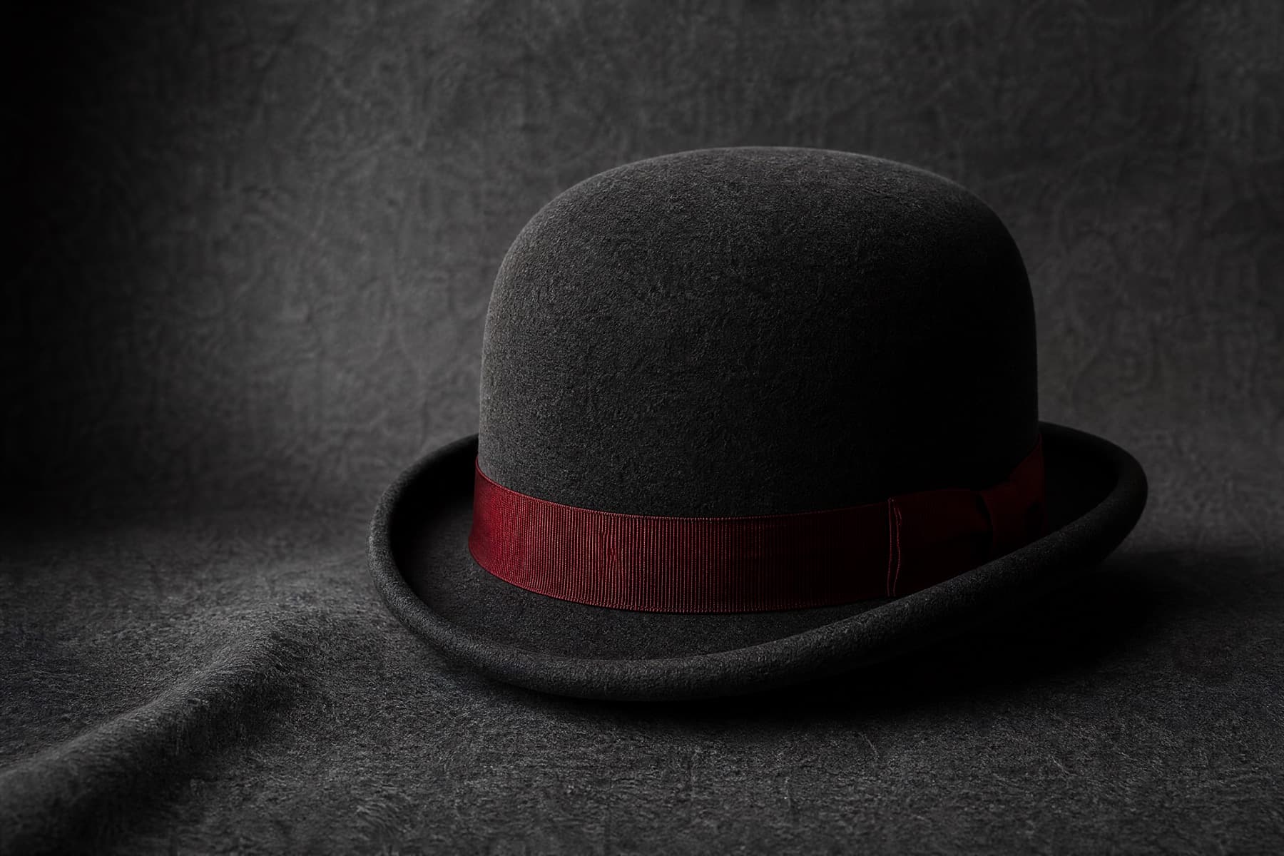 Bowler Rabbit: charcoal felt hat photographed whole under a single hard side light