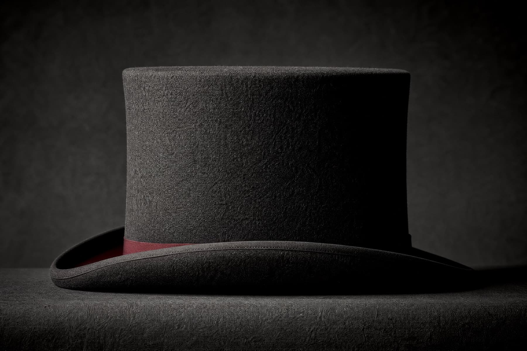 Top Hat Short: charcoal felt hat photographed whole under a single hard side light