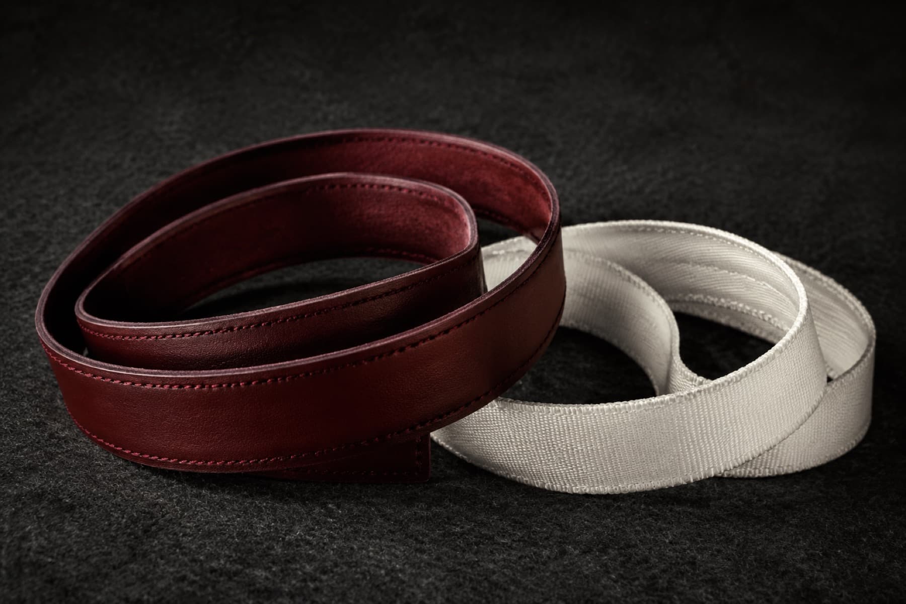 Two coiled replacement sweatbands, one wine leather and one bone woven ribbon